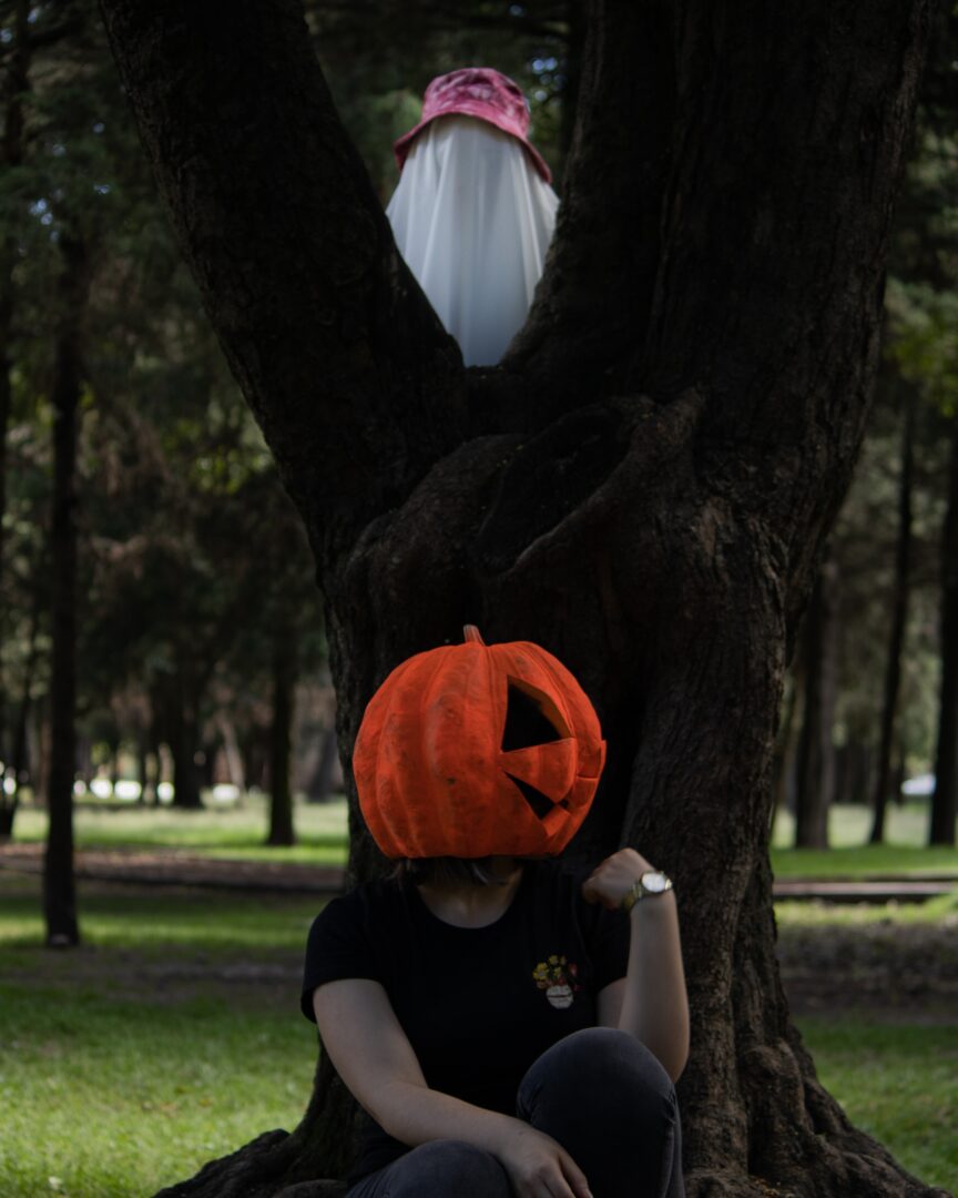 Girl wearing pumpkin on the head