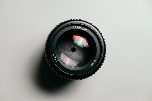 Black AF Nikkor Lens on Table