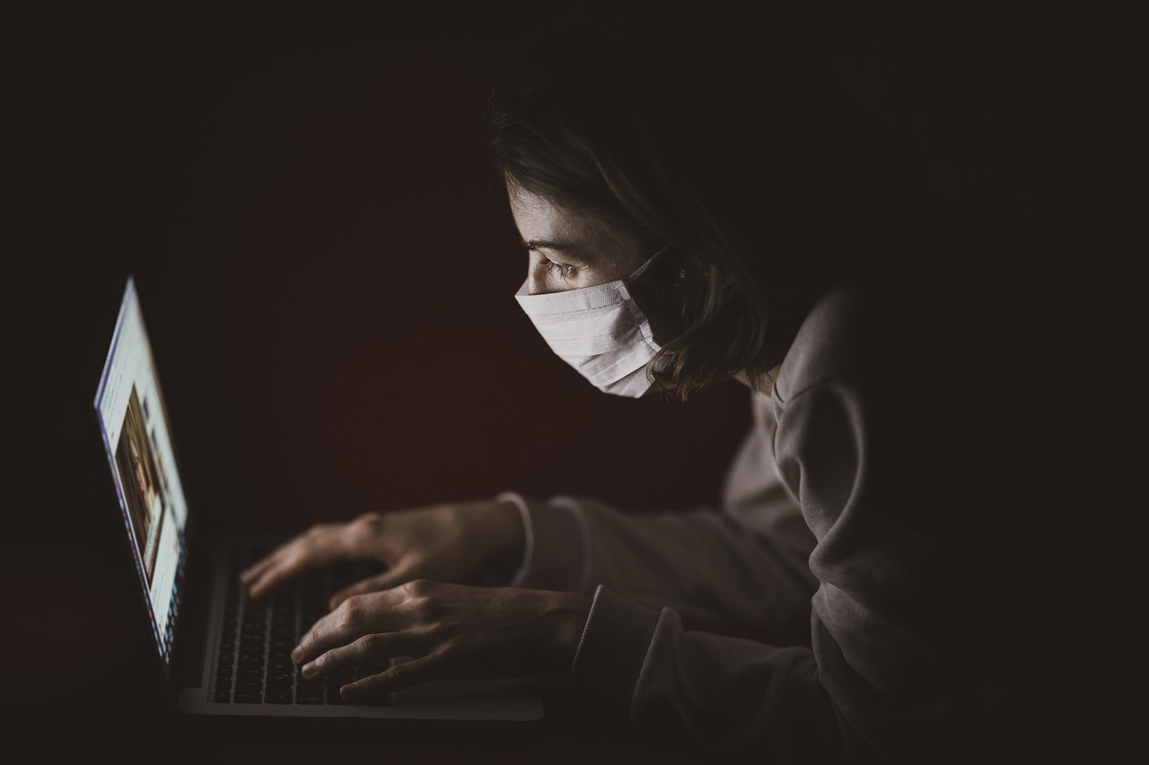 Lady with Mask on Laptop
