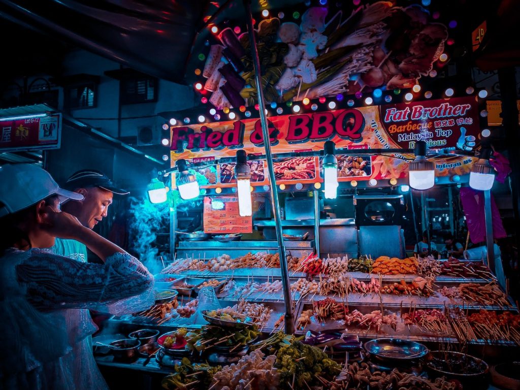 Customer Choosing Raw Kebab In Street Stall at Night